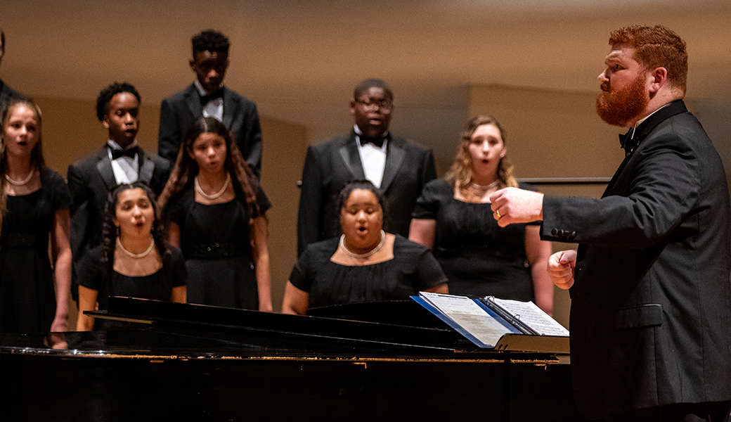 a choir performs in the Moody Music Building concert hall
