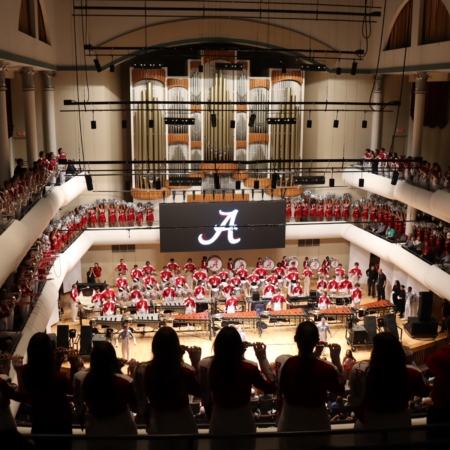 Million Dollar Band members filling the stage and balconies of the Moody Music Building Concert Hall