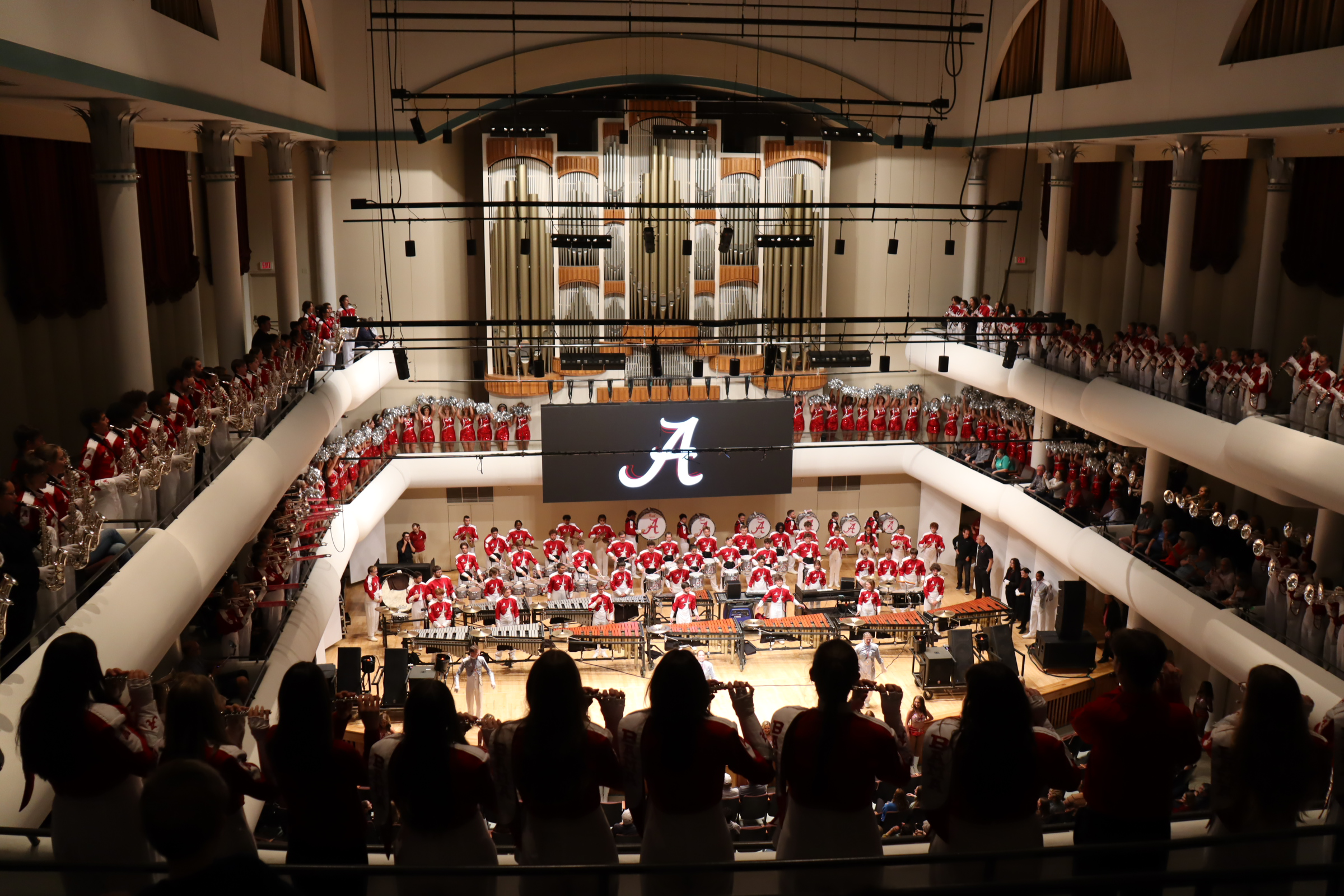 Million Dollar Band members filling the stage and balconies of the Moody Music Building Concert Hall