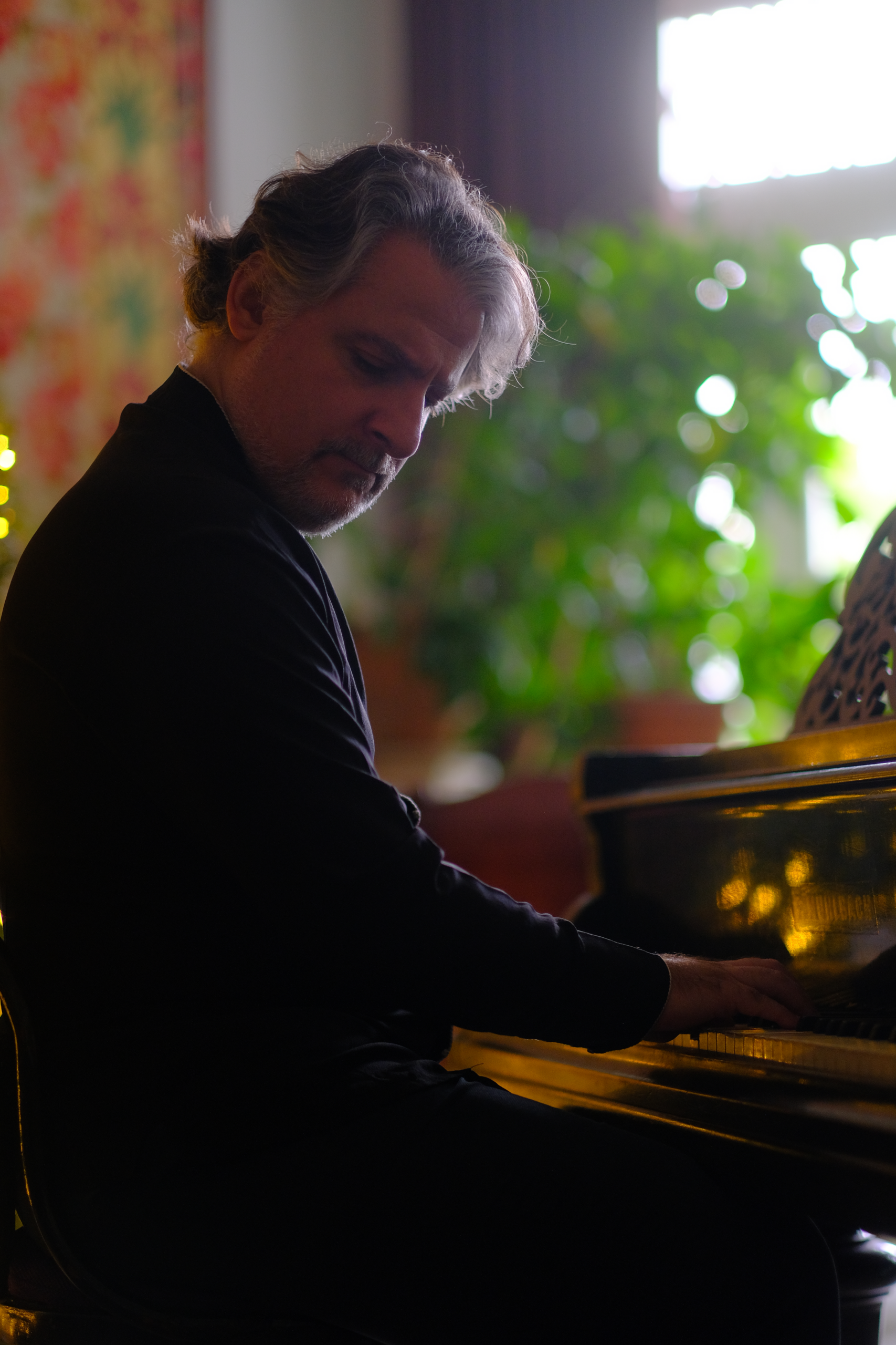 Dr. Edisher Savitski playing the piano